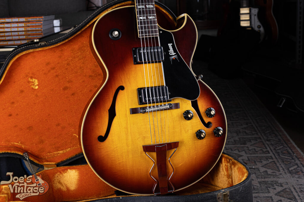 Shot of a 1968 Gibson ES-175D in Sunburst finish with two humbuckers, featuring a rare gold 'Gibson' logo on the pickguard and an original bridge with nylon saddles.