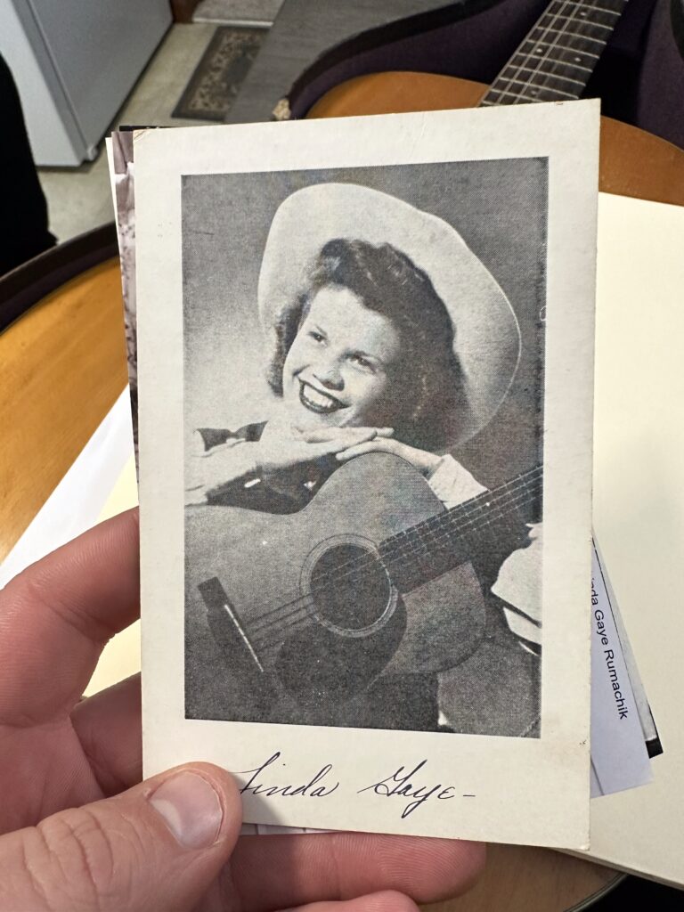 Black and white 1950s historical photo of Linda playing her vintage Martin 0-18 on the radio. Joe’s Vintage Guitars specializes in buying Martin guitars with documented history and provenance. Get a free professional Martin guitar evaluation and market value assessment.